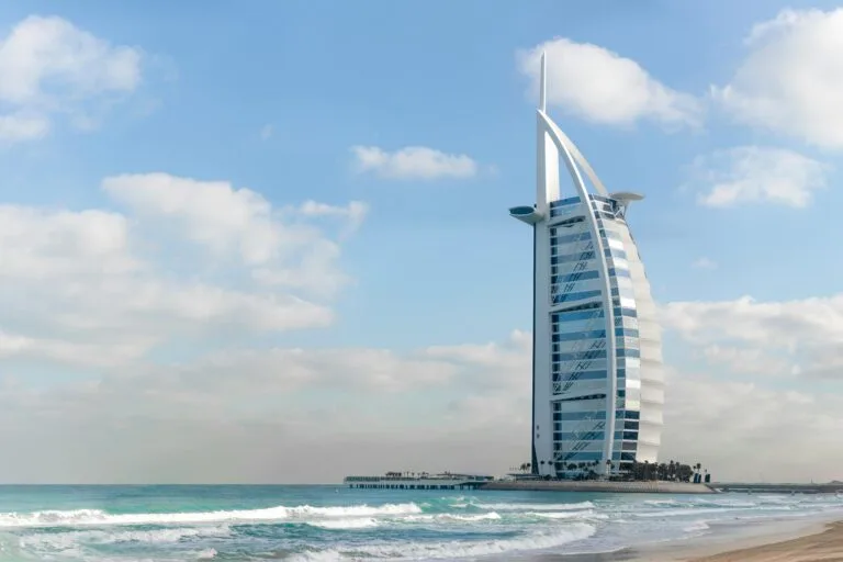 BenaInvest – Building Your Real Estate Portfolio with Confidence 4 Stunning view of Burj Al Arab with a serene beach setting in Dubai, UAE.